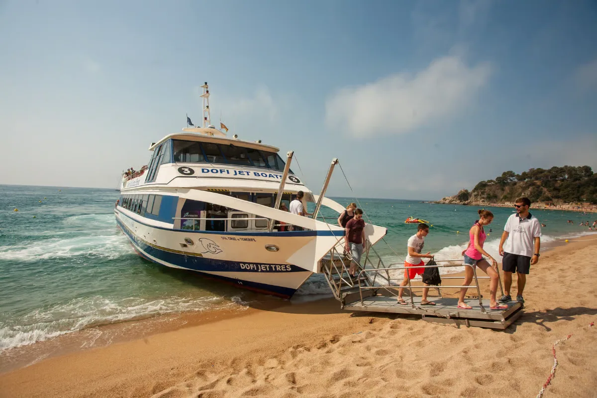 Boat tour along Costa Brava coastline with dramatic cliffs