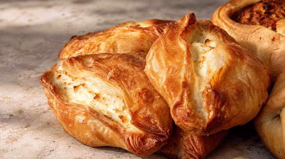 Pastizzi split open showing the flaky pastry and ricotta filling