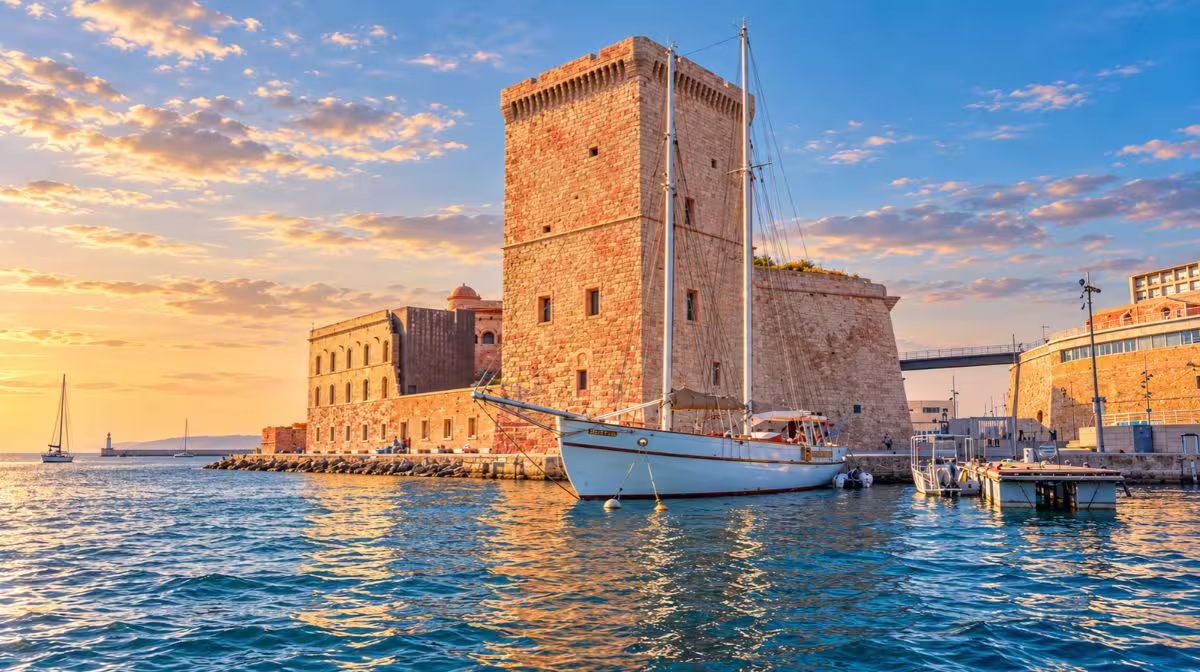 Yachts and fishing boats moored in the Old Port of Marseille, the Vieux-Port, with Notre-Dame de la Garde above